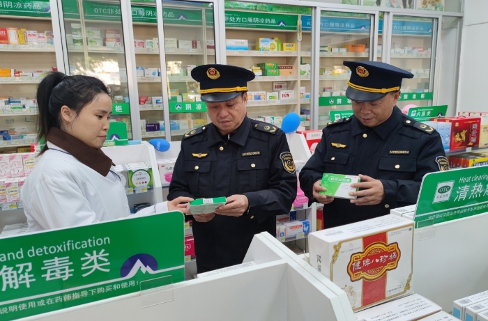 圖為執法人員在藥店檢查抗病毒類藥品質量情況。