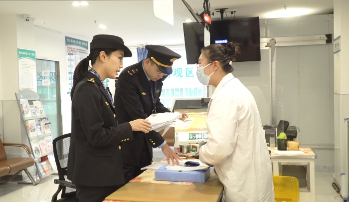 圖為該局執法人員檢查安禾綜合門診部疫苗采購、運輸和儲存記錄單。